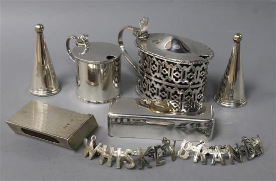 A late Victorian silver mustard, a silver match sleeve and six plated items including pair of wine labels, mustard and snuff box.